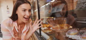 a happy woman who watches at confectionary shelf that shows how Flavors Attract More Customers