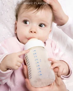 a newborn baby drinking milk from the bottle