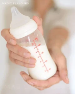 a milk bottle at the mother's hands