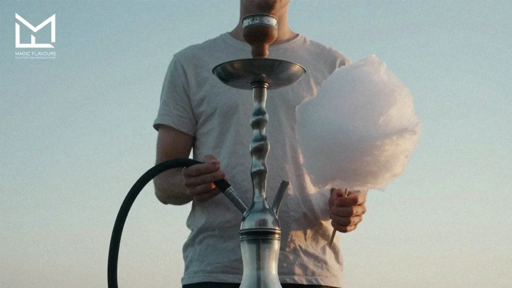 man grabs a cotton candy in one hand and hookah in another hand 