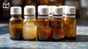 Amber flavor concentrate bottles showing sediment and color change from oxidation and storage, causes of off-flavors